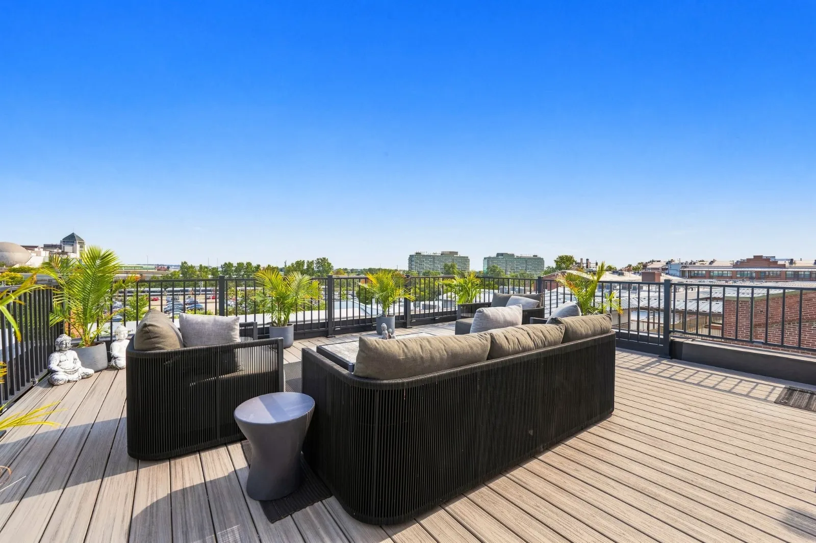 The rooftop terrace with woven lounge seating and the Jersey City and Manhattan skylines beyond