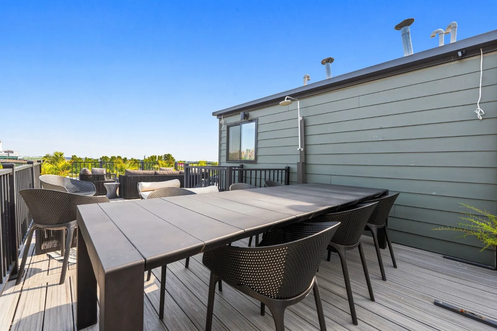 Rooftop dining table for eight beneath an open sky