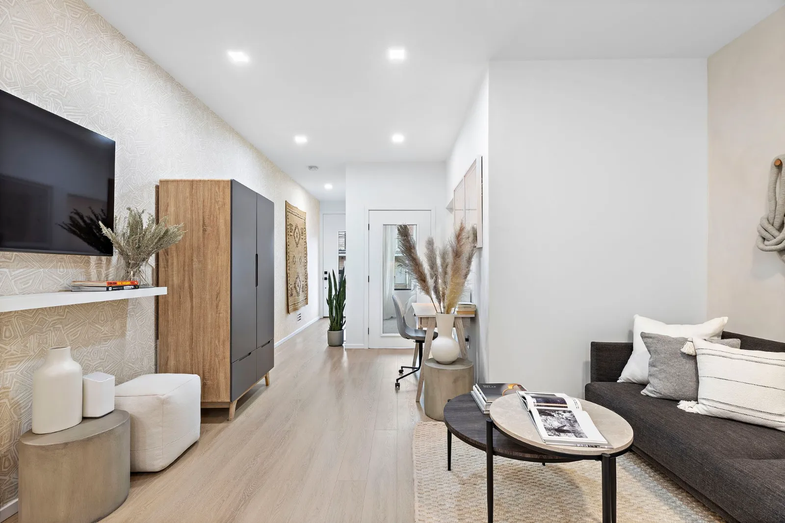 Second residence living area with a sofa, coffee table and wood cabinetry